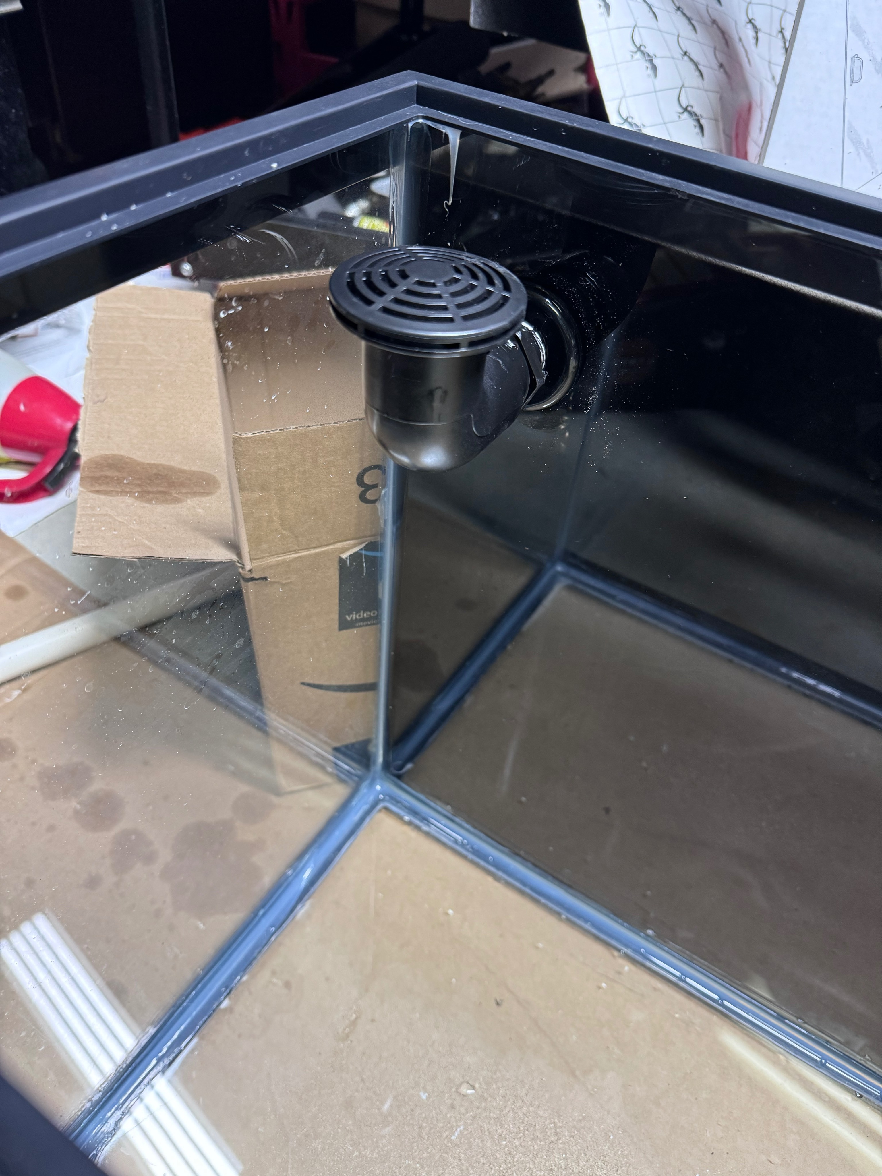 Internal aquarium overflow using a PVC elbow directing water from the display tank to the sump