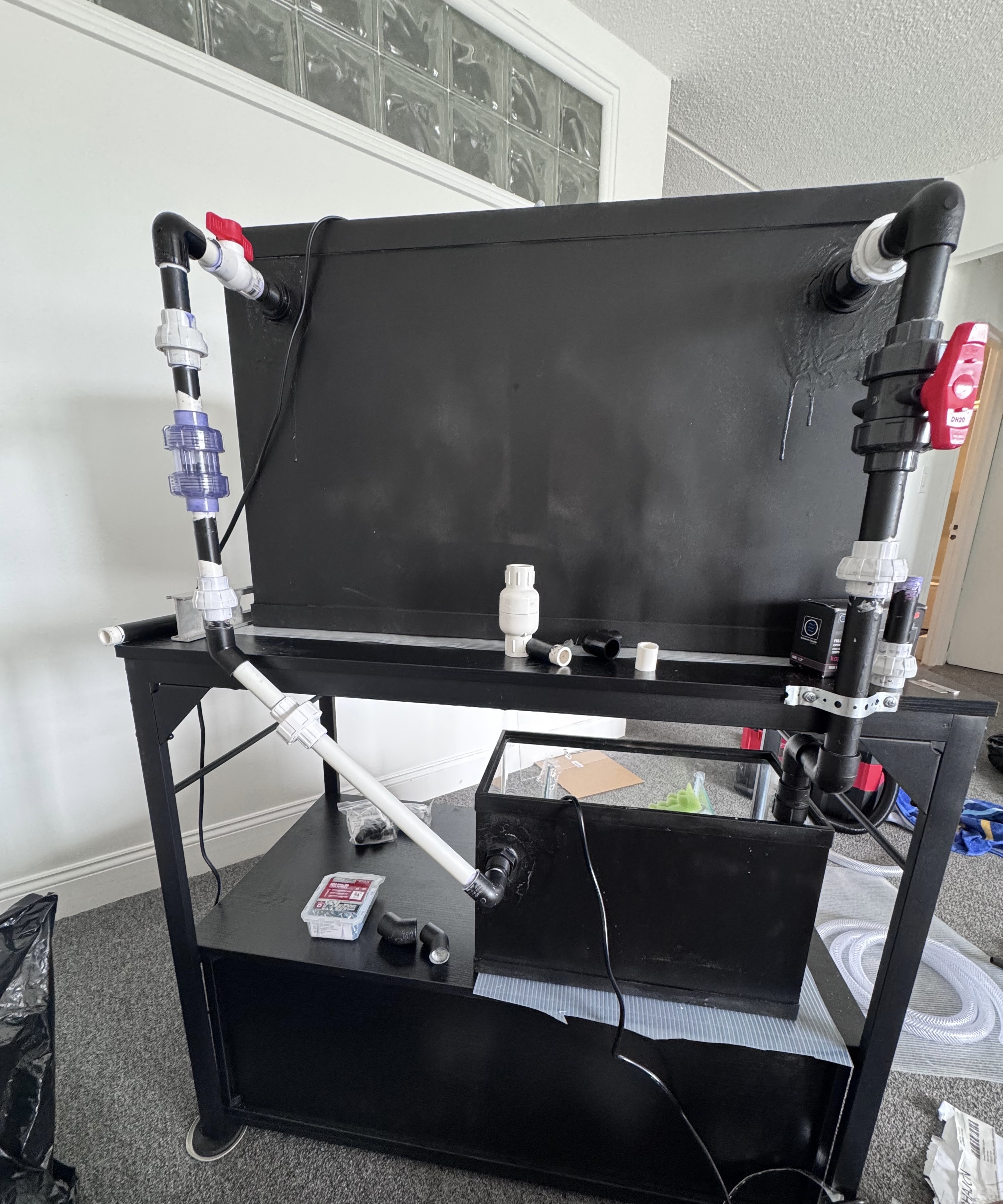 Aquarium sump and display tank water flow path showing undergravel and refugium circulation