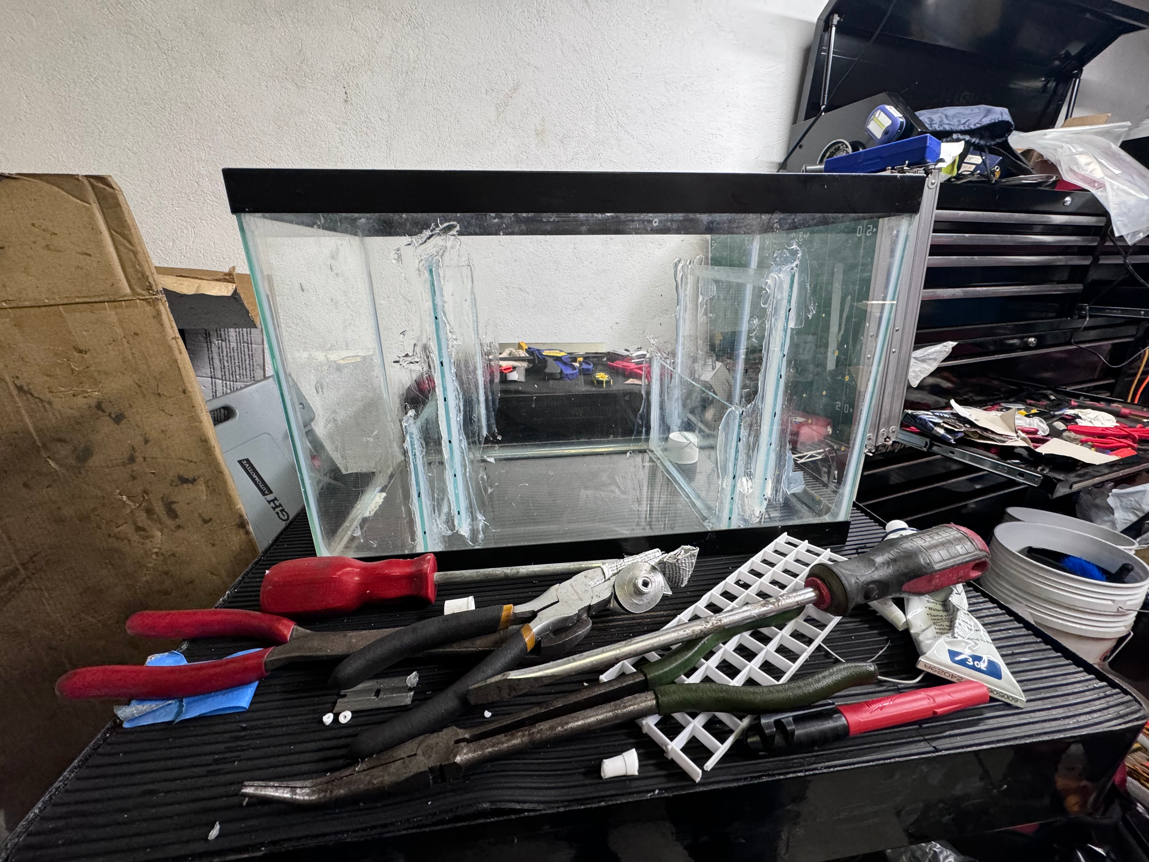 Glass baffle installation in progress on a workbench for a freshwater sump build