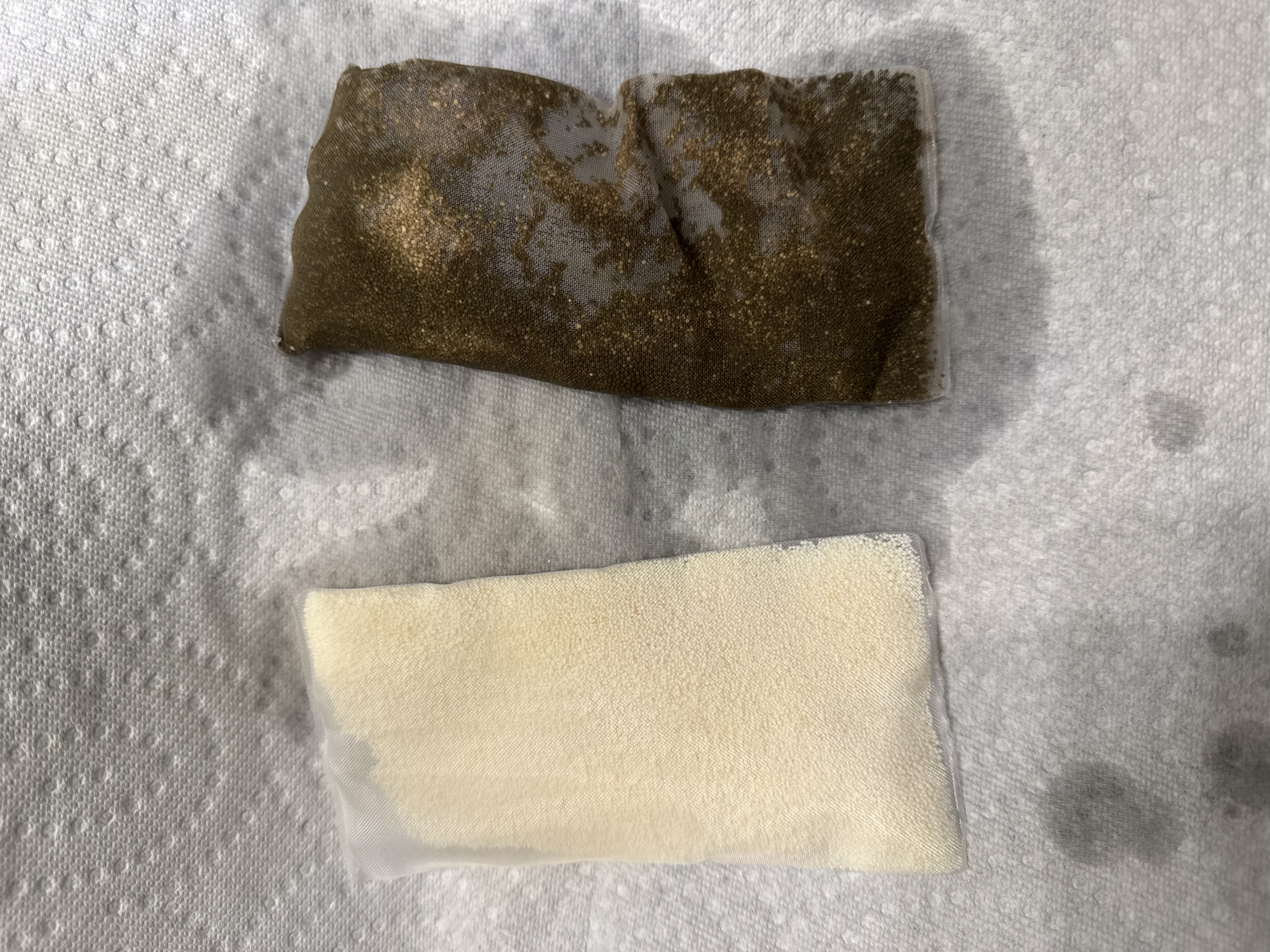 Seachem Purigen comparison showing fresh beige bag and exhausted dark brown bag after filtering aquarium water
